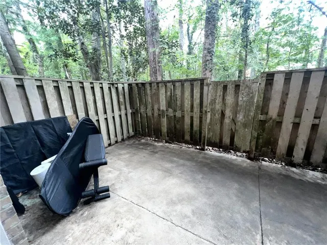 a view of outdoor space with wooden floor and wooden fence