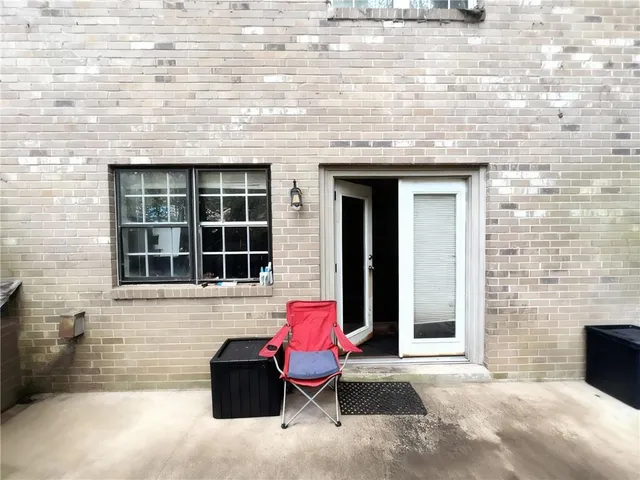 a view of a brick house with a bench in front of door
