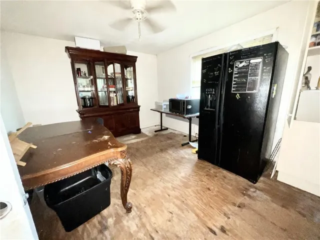 a living room with stainless steel appliances kitchen island a stove and a refrigerator