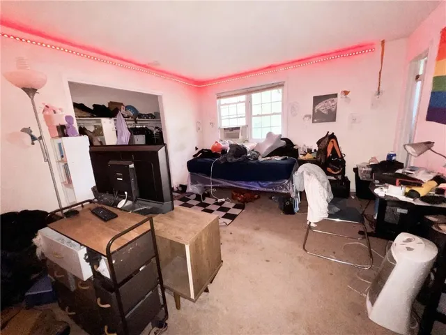 a room with furniture a rug and a window