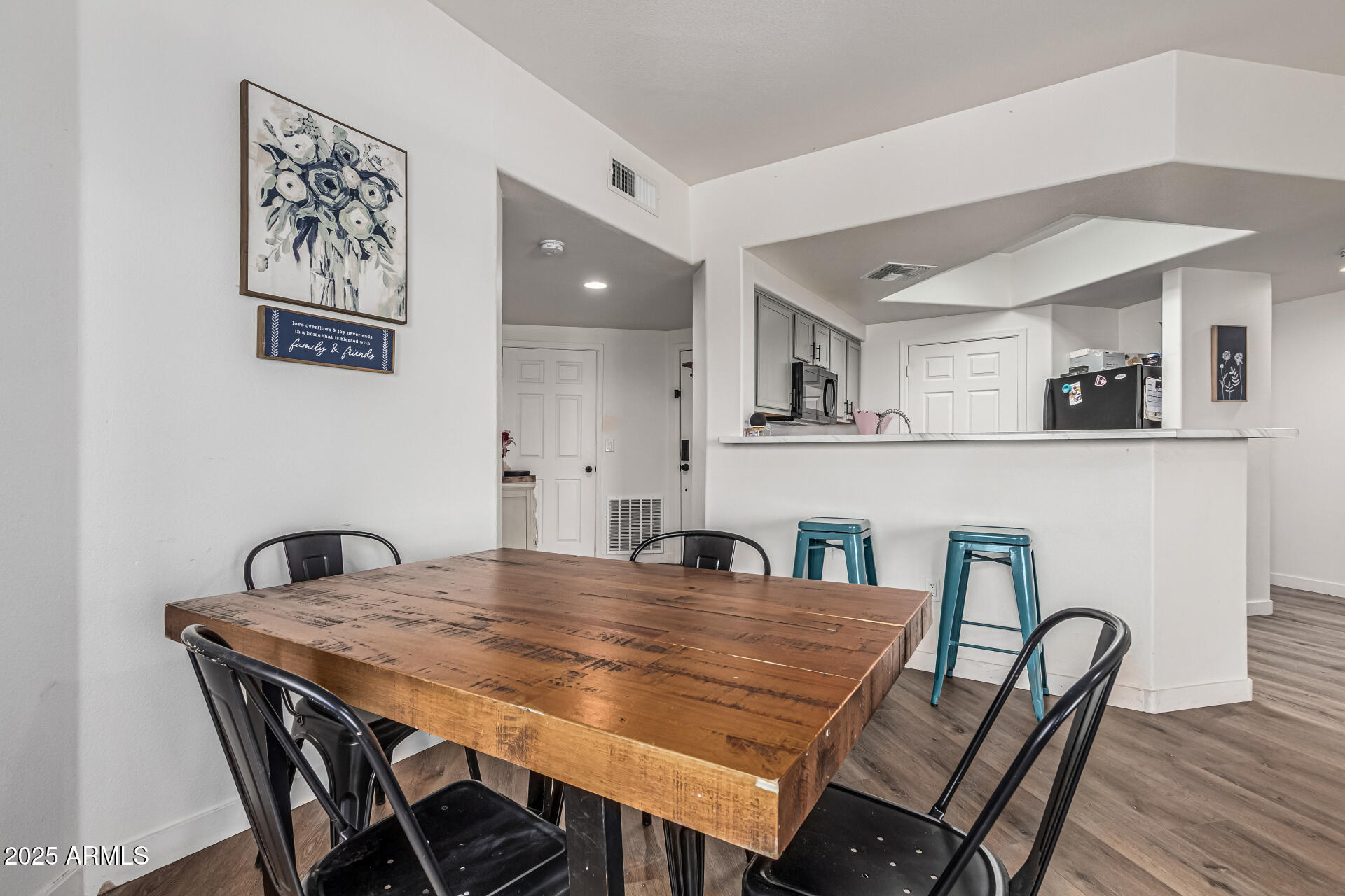 10030 West Indian School Road, Unit 255 Phoenix, AZ 85037 - Photo 8 of 27 a dining room with furniture and wooden floor
