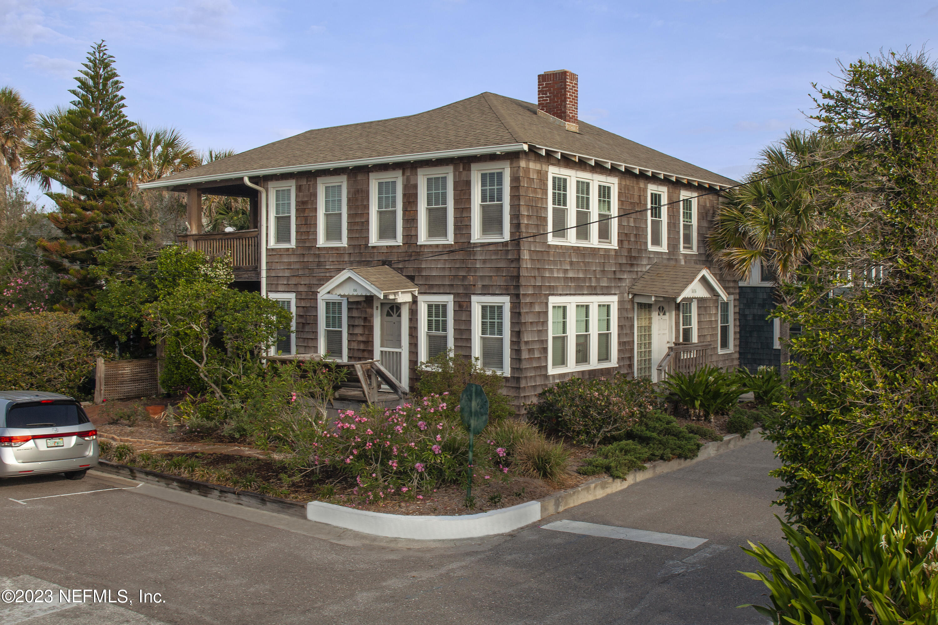 a front view of a house with a garden