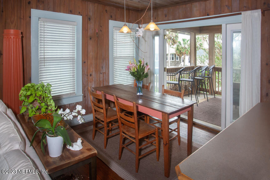1416 Strand Street Neptune Beach, FL 32266 - Photo 13 of 27 a dining room with furniture and wooden floor