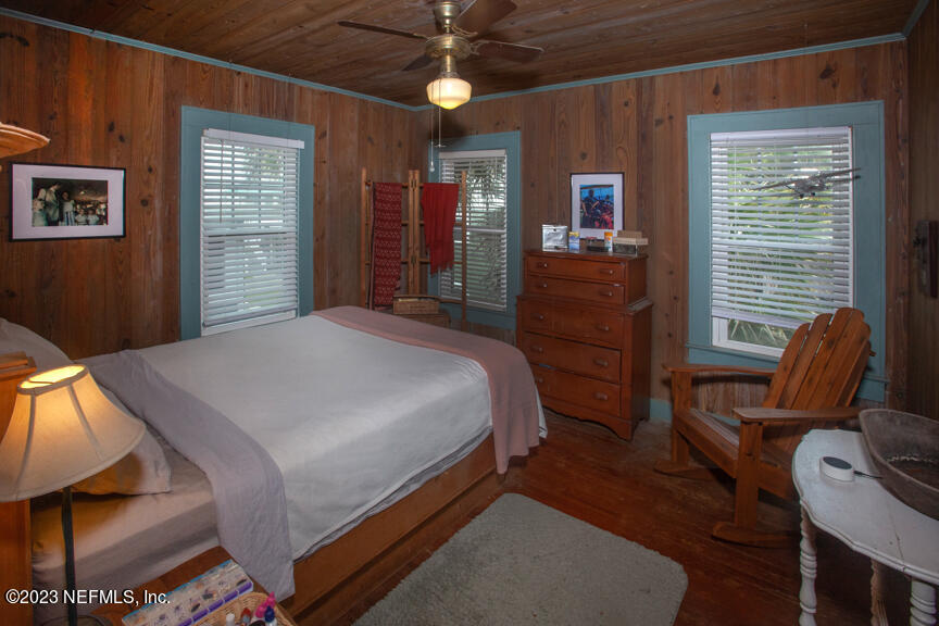1416 Strand Street Neptune Beach, FL 32266 - Photo 20 of 27 a bedroom with a bed and wooden floor