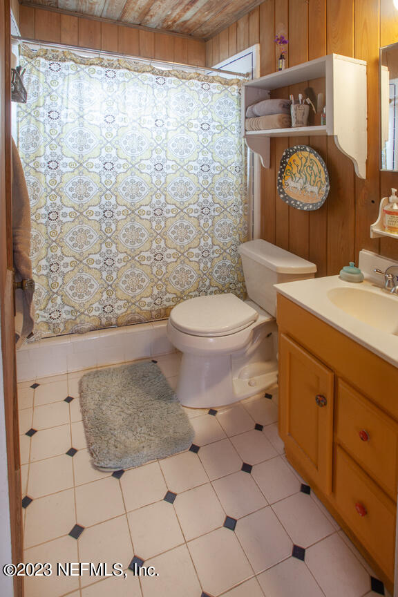 1416 Strand Street Neptune Beach, FL 32266 - Photo 23 of 27 a bathroom with a granite countertop toilet and a sink