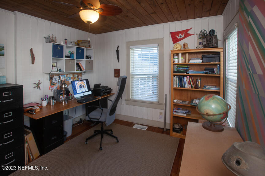 1416 Strand Street Neptune Beach, FL 32266 - Photo 6 of 27 a workspace with furniture and bookshelf
