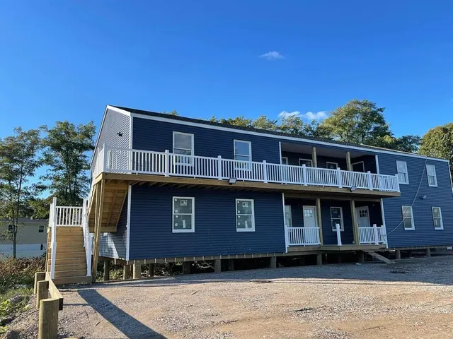 a front view of a house with a garden