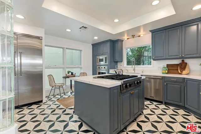 a kitchen with a sink and chairs