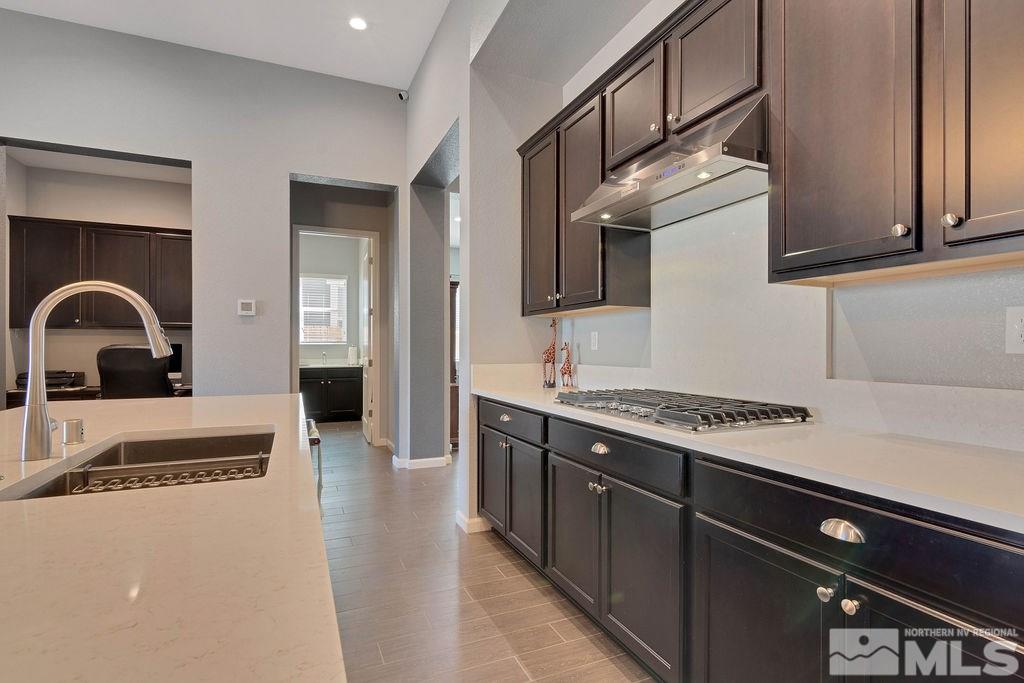 2335 Buttermere Drive Reno, NV 89521 - Photo 7 of 37 a kitchen with stainless steel appliances granite countertop a stove a sink and a refrigerator