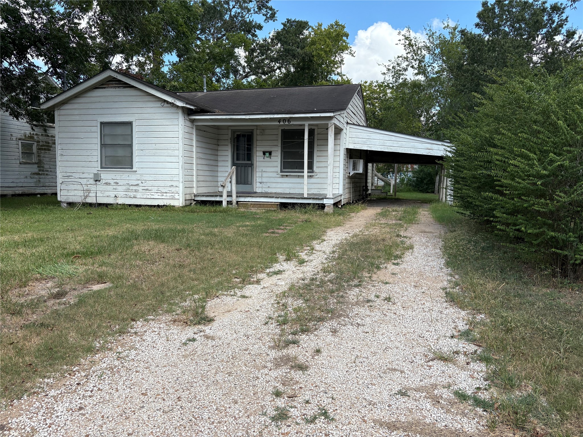 406 Omega Street El Campo, TX 77437 - Photo 2 of 13 a front view of a house with a garden