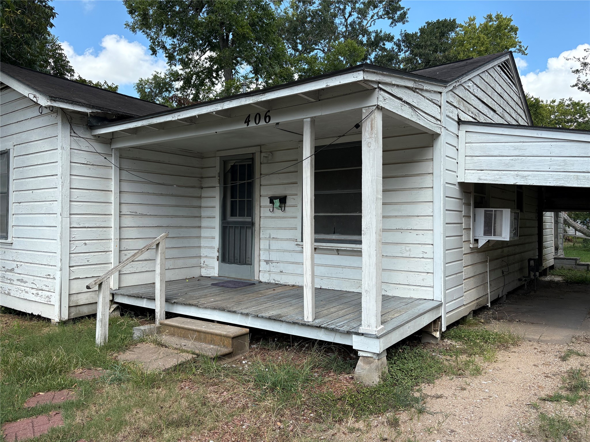 406 Omega Street El Campo, TX 77437 - Photo 3 of 13 a view of house with a large window and wooden fence