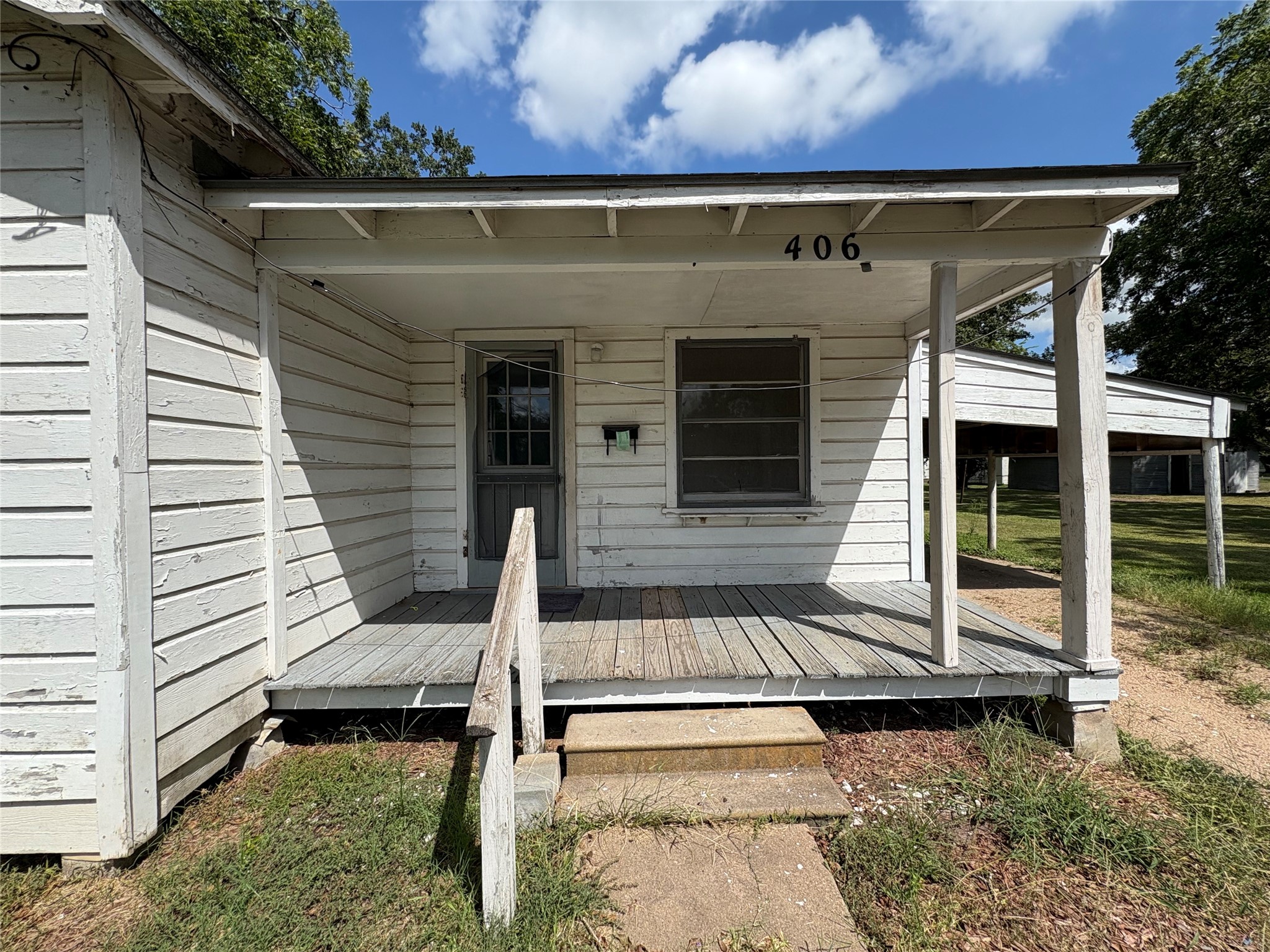 406 Omega Street El Campo, TX 77437 - Photo 4 of 13 a view of a house with a door and a chair