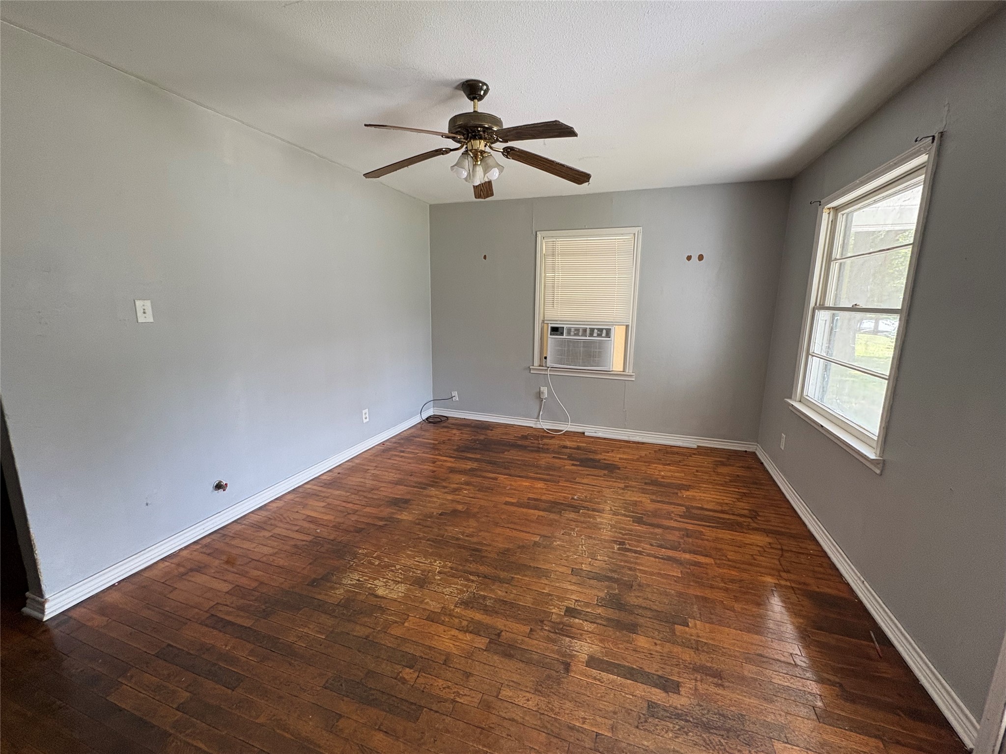 406 Omega Street El Campo, TX 77437 - Photo 10 of 13 a view of empty room with wooden floor and fan