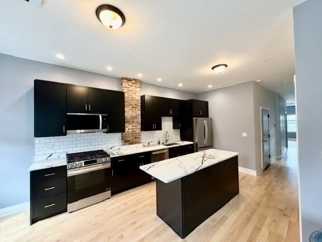 301 North Street, Unit 5 Boston, MA 02113 - Photo 1 of 18 a large kitchen with a large counter top appliances and cabinets
