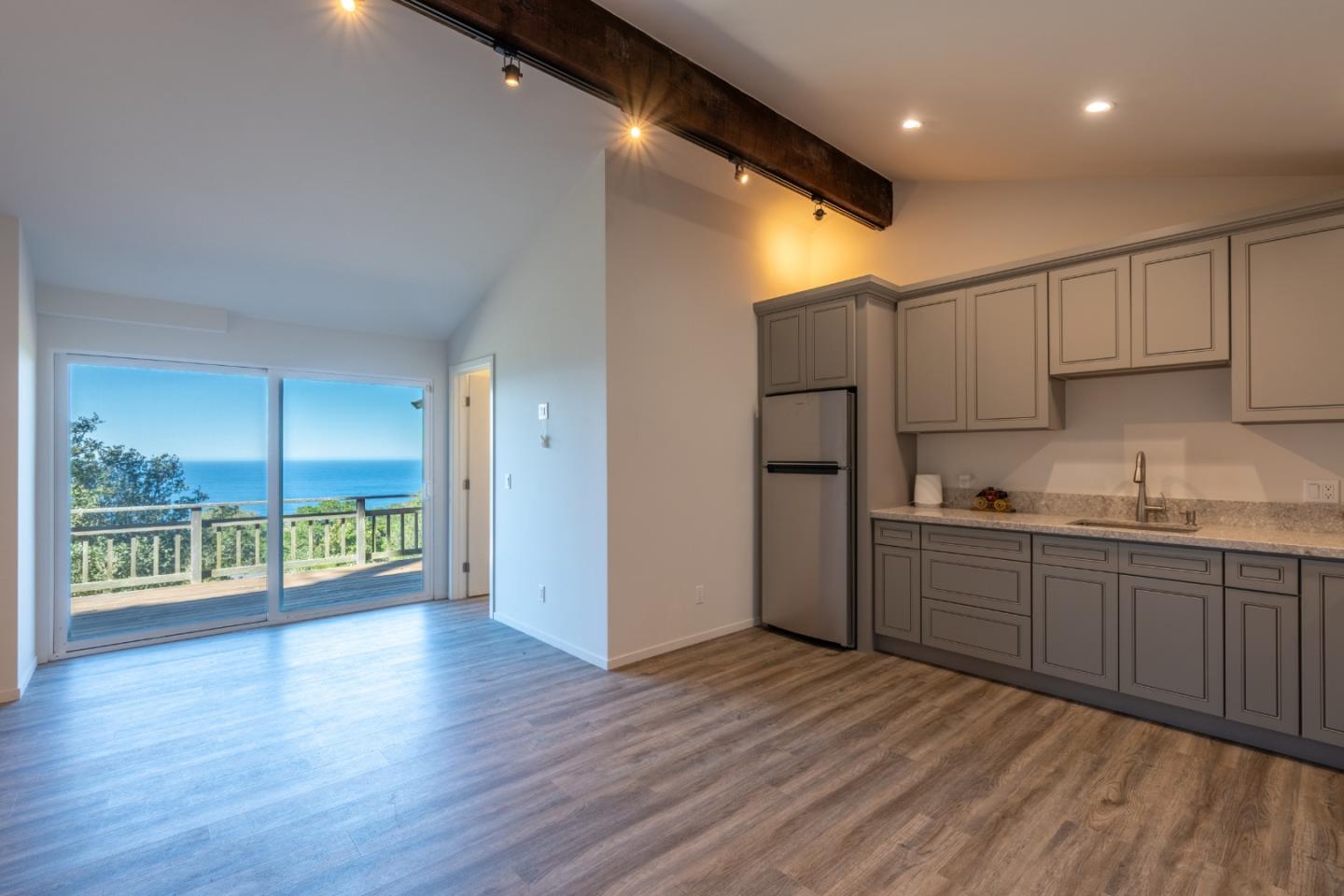 214 Crest Road Carmel, CA 93923 - Photo 22 of 29 a kitchen with stainless steel appliances granite countertop a refrigerator a sink and wooden floors