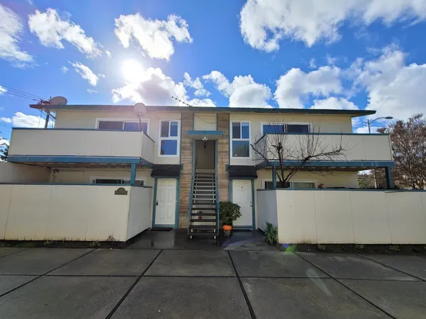 a view of a house with a barbeque grill and a fireplace