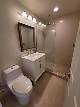 a bathroom with a toilet sink and mirror