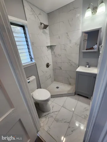 a bathroom with a toilet and a shower