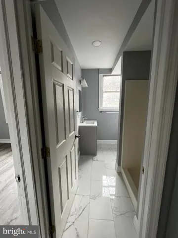 a bathroom with a sink a toilet and a shower