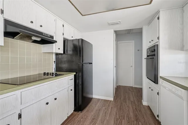 a kitchen with stainless steel appliances a refrigerator sink and cabinets