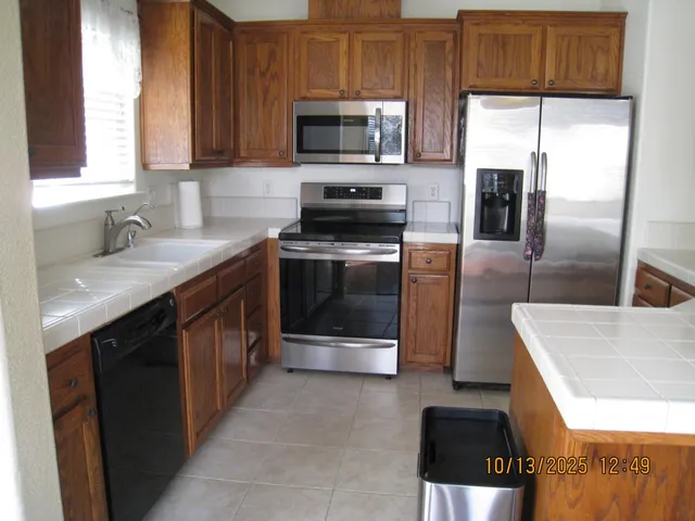 a kitchen with a sink stove and refrigerator