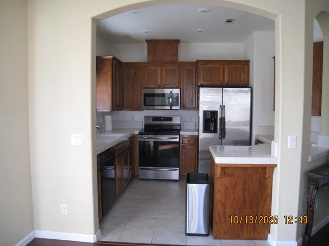a kitchen with a refrigerator sink and stove
