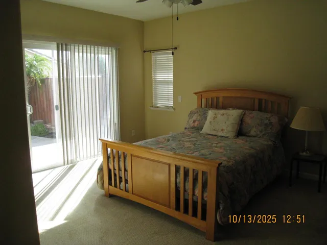 a bed sitting in a bedroom next to a window