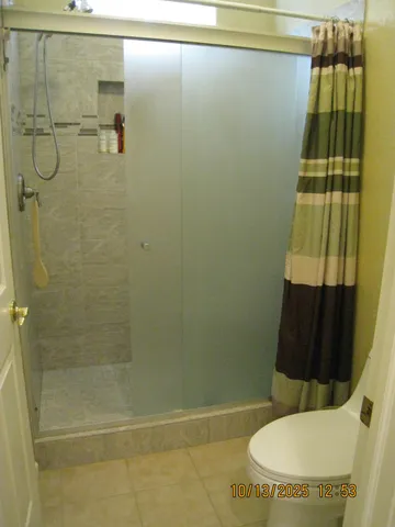 a bathroom with a toilet and shower