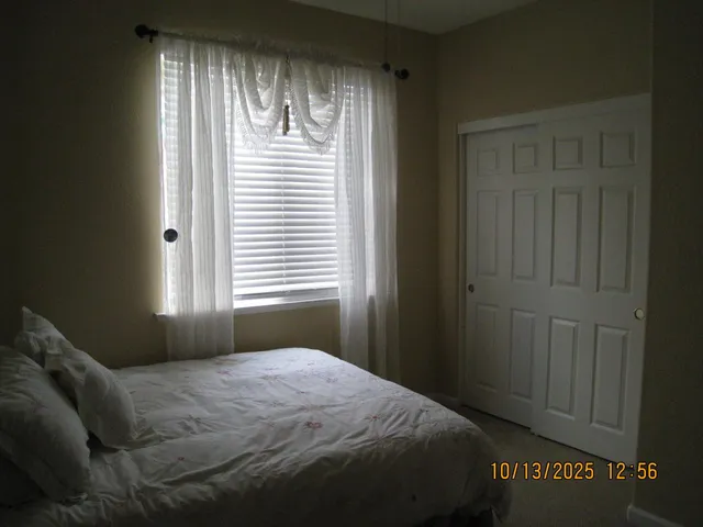 a bedroom with a bed and a window