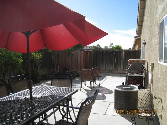 a view of backyard with outdoor seating a patio and a garden