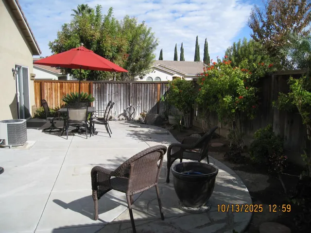 a view of a patio with furniture and backyard