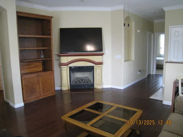 a living room with furniture flat screen tv and a fireplace