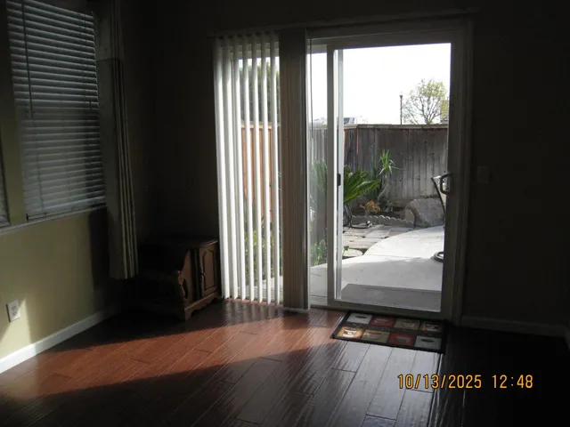 a view of a room with wooden floor and a window