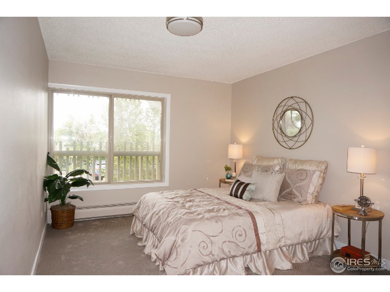 2707 Valmont Road, Unit 210D Boulder, CO 80304 - Photo 10 of 13 a bedroom with a bed and a large window