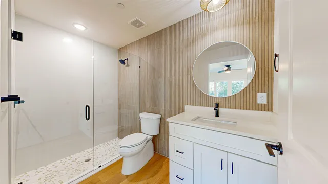 a spacious bathroom with stainless steel appliances a sink and a bathtub