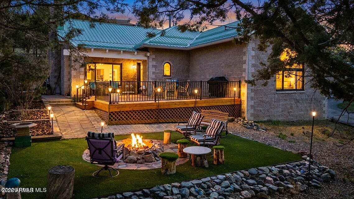 4969 West Iron Springs Road Prescott, AZ 86305 - Photo 1 of 44 a view of a patio with table and chairs potted plants and large tree