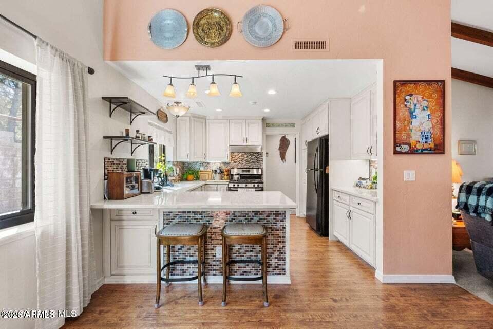 4969 West Iron Springs Road Prescott, AZ 86305 - Photo 19 of 44 a view of a kitchen and dining area with chandelier