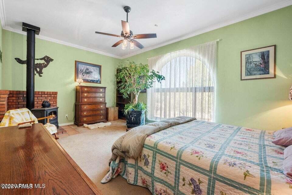 4969 West Iron Springs Road Prescott, AZ 86305 - Photo 23 of 44 a bedroom with a bed and a chandelier