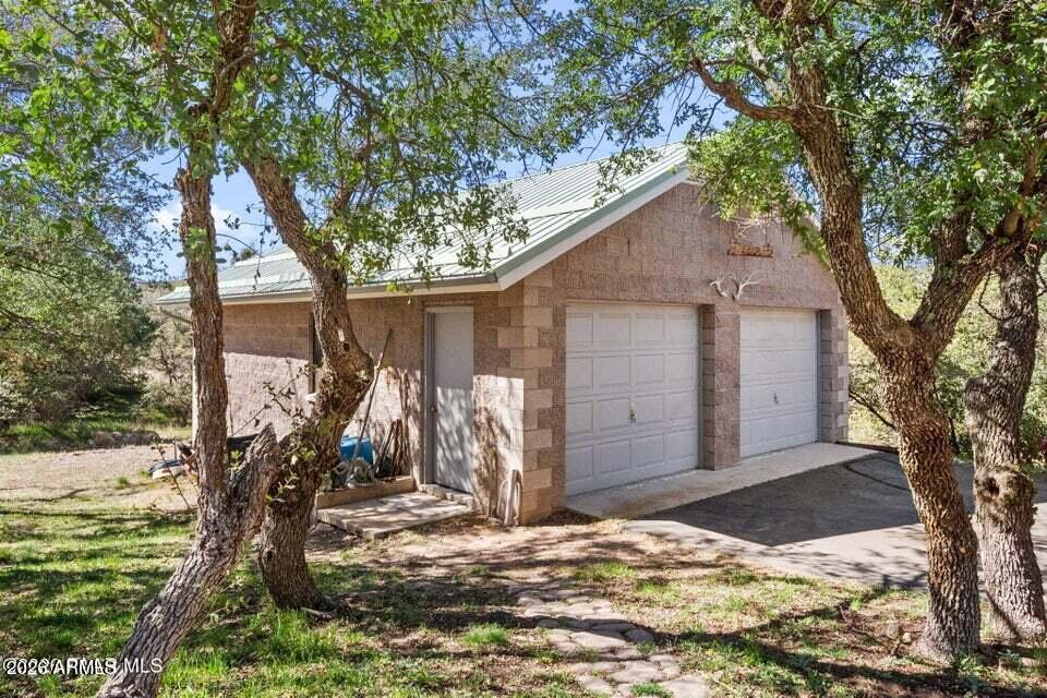 4969 West Iron Springs Road Prescott, AZ 86305 - Photo 32 of 44 a wooden house with tree in front of it