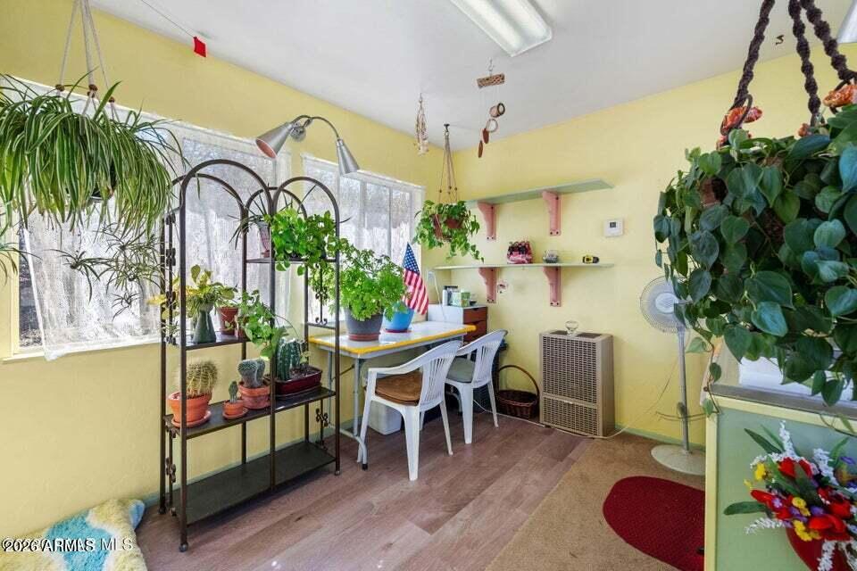 4969 West Iron Springs Road Prescott, AZ 86305 - Photo 34 of 44 a dining room with furniture potted plants and wooden floor