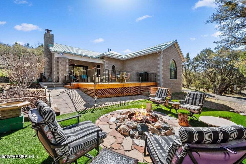 4969 West Iron Springs Road Prescott, AZ 86305 - Photo 5 of 44 a view of a patio with couches table and chairs with plants and wooden fence