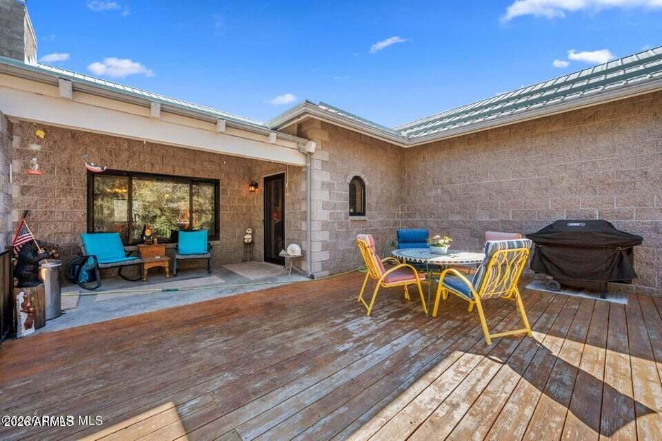 4969 West Iron Springs Road Prescott, AZ 86305 - Photo 8 of 44 a backyard of a house with table and chairs
