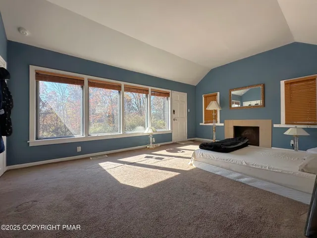 a living room with furniture large window and flat screen tv