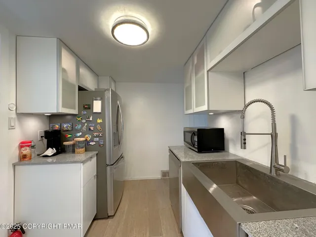 a kitchen with a sink a stove and cabinets