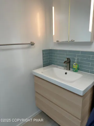 a bathroom with a tub and cabinets