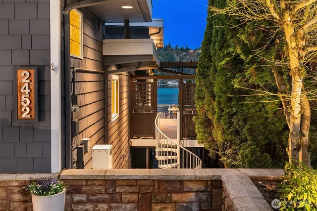 a view of a backyard with couches and wooden fence