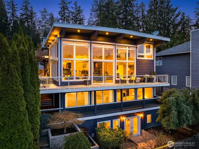 a living room with furniture and floor to ceiling windows