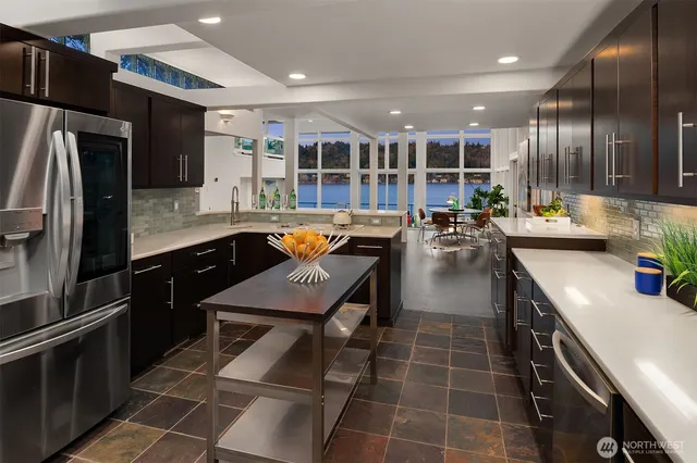 a kitchen with stainless steel appliances a sink stove and refrigerator
