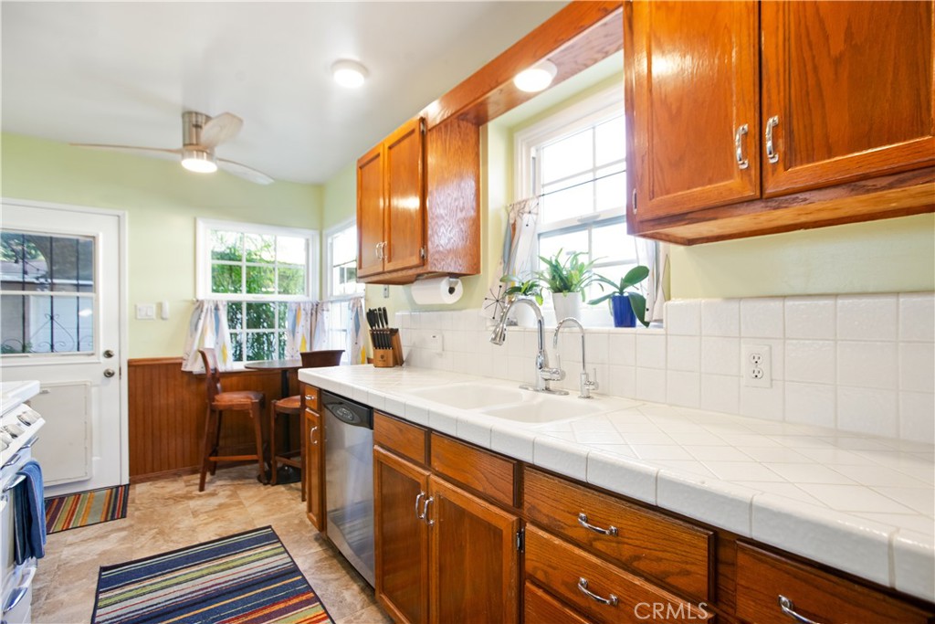 9253 Rose Street Bellflower, CA 90706 - Photo 12 of 36 a kitchen with stainless steel appliances granite countertop a sink and cabinets
