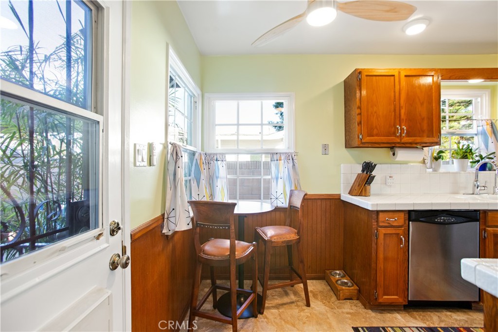 9253 Rose Street Bellflower, CA 90706 - Photo 14 of 36 a dining room with a table chairs and a sink